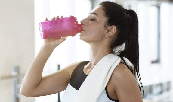 Frau trinkt Proteinshake Ist zu viel Eiweiß Konsum schädlich?